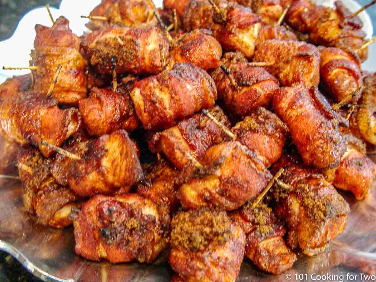 pile of cooked bacon wrapped chicken on a platter.