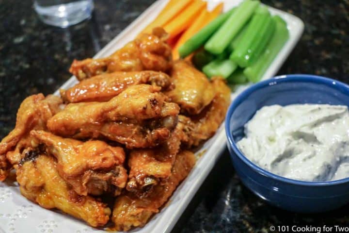 platter of wings with veggies and dipping sauce