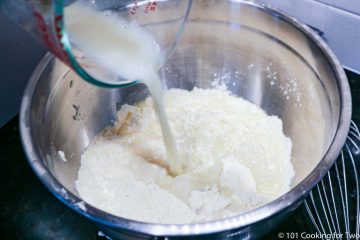 pouring milk into the dry ingredients