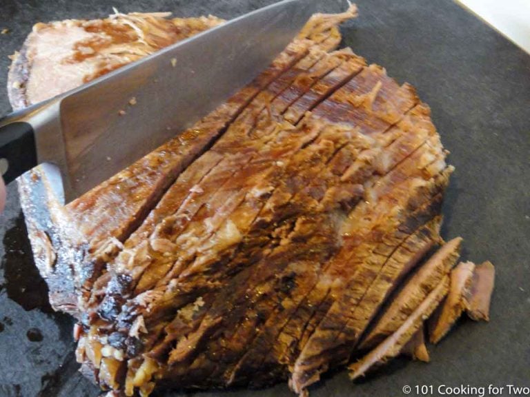 slicing the cooked brisket cross-grain