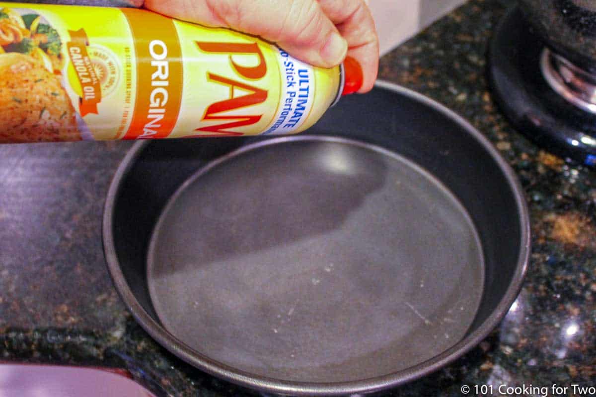 spraying PAM into baking pan