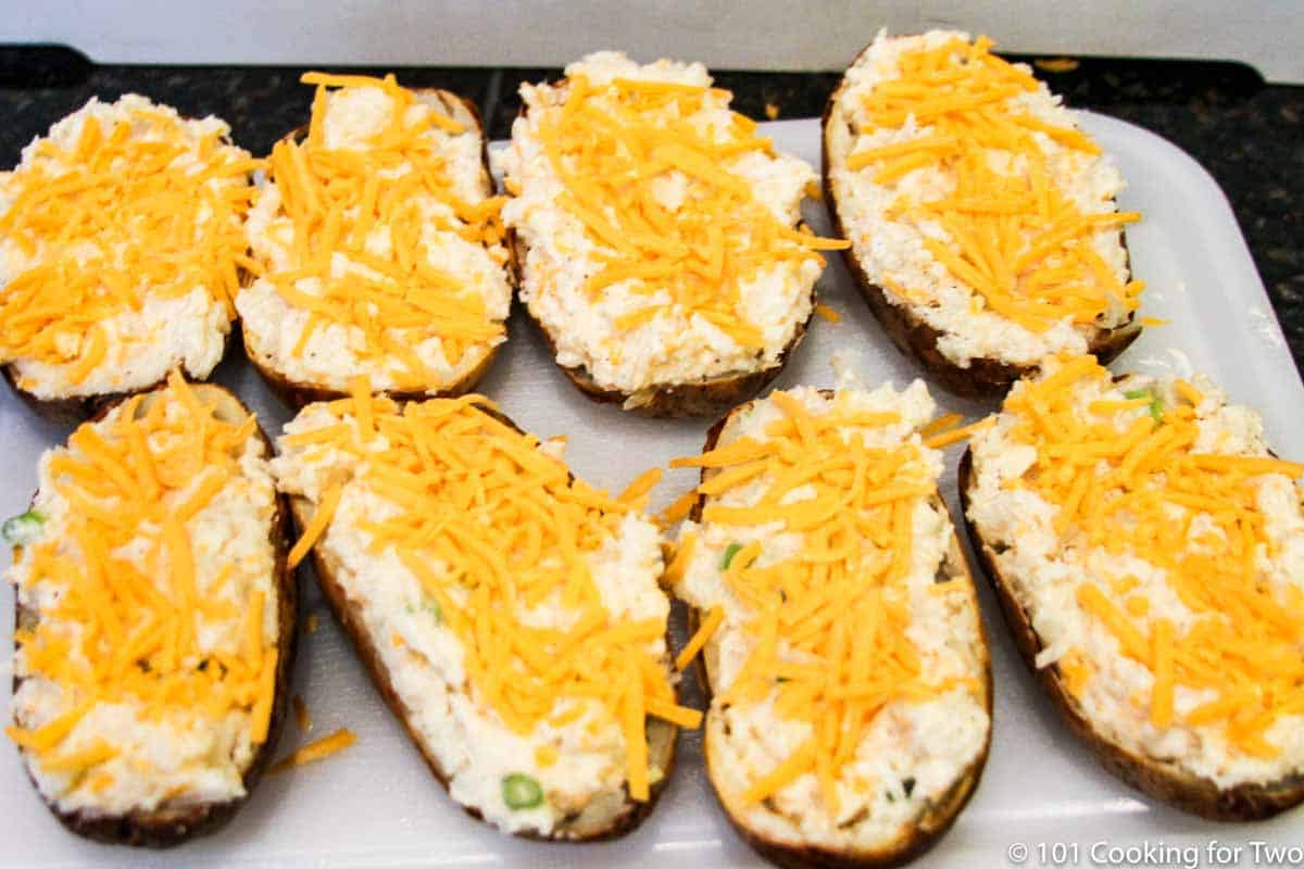 stuffed potatoes with cheese on top.