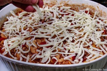 topping the casserole with cheese