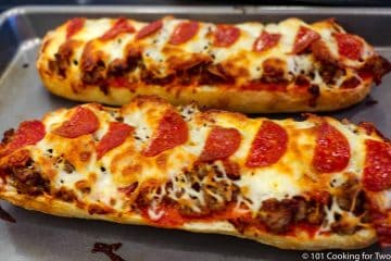 French bread pizzas coming out of oven