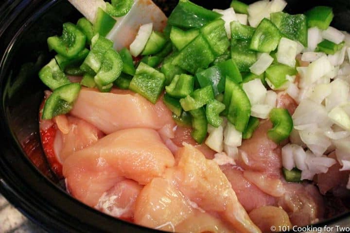 adding chicken and veggies to the crock pot