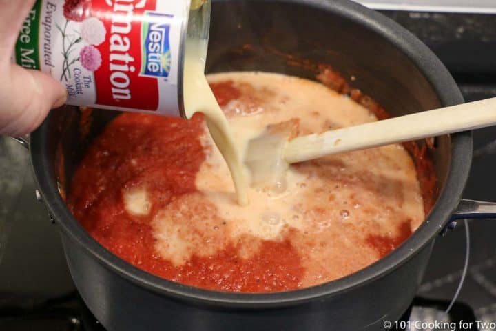 adding evaperated milk to the soup