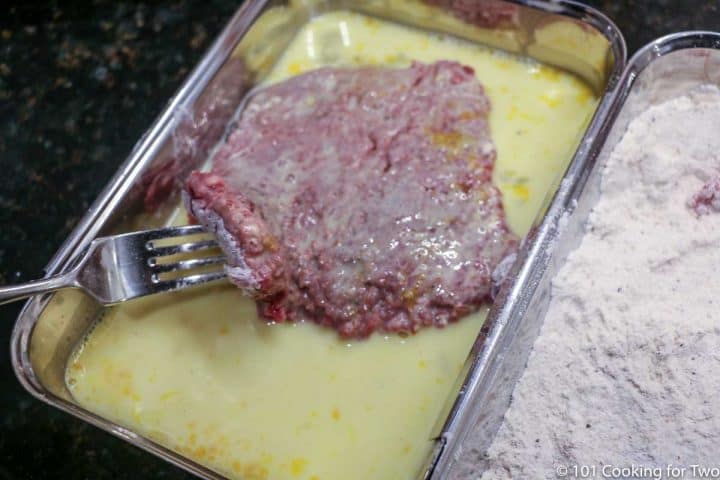 coating the meat with egg mixture