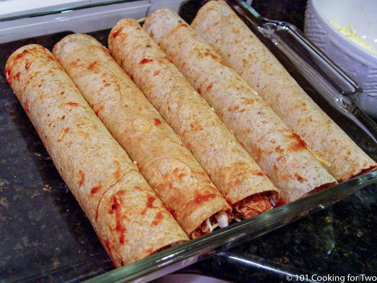 enchiladas rolled up in baking pan.