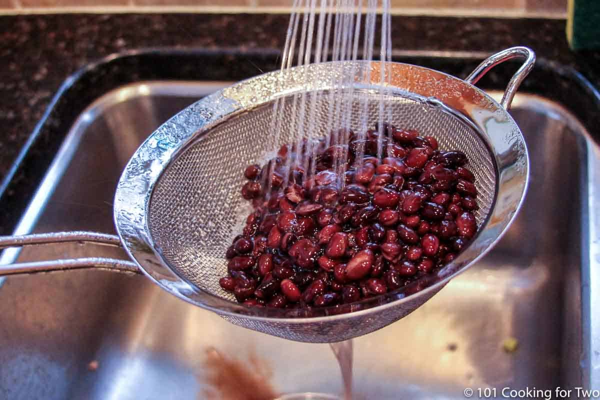 rinsing black beans under running water