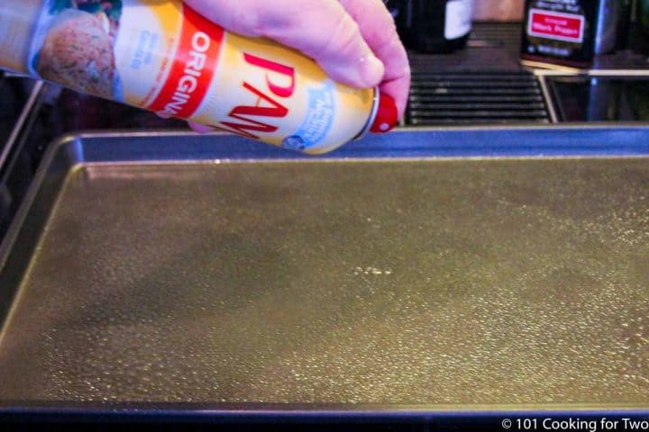 spraying baking tray with PAM