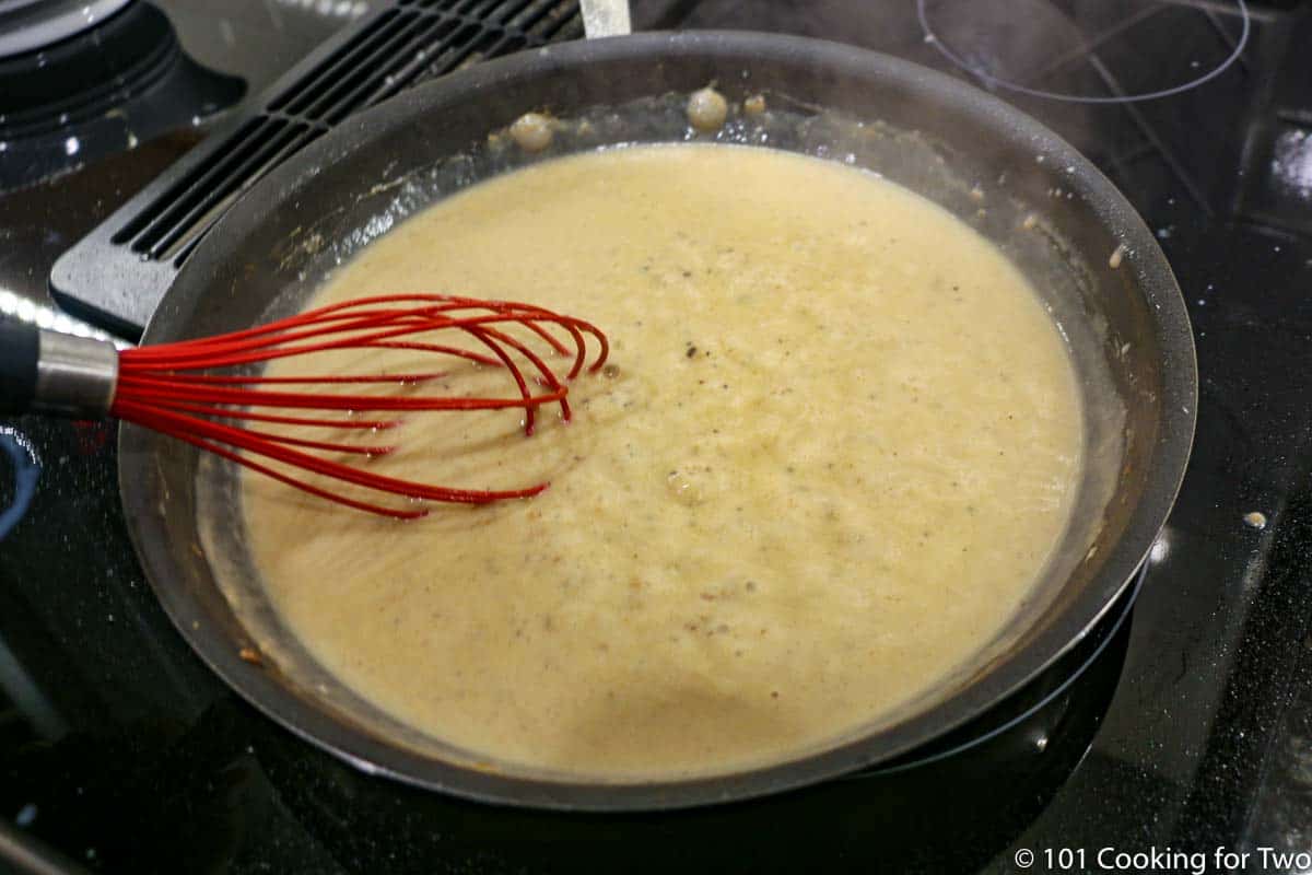 whisking gravy until thickened.