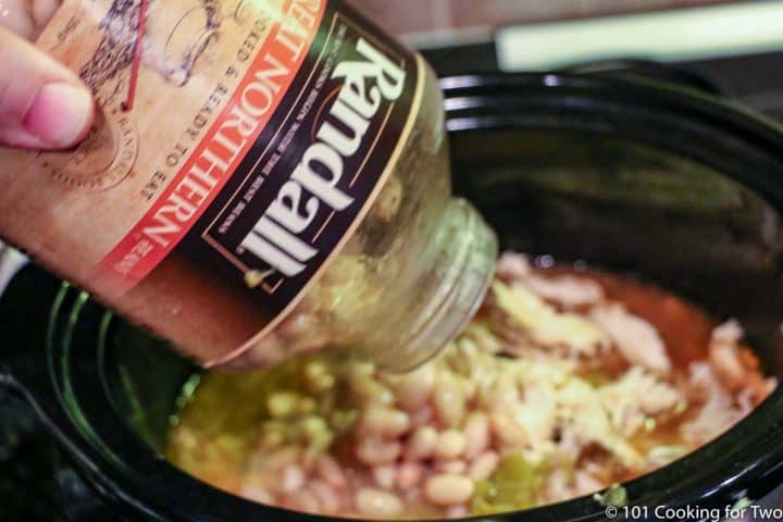 adding a jar of beans to the crock pot