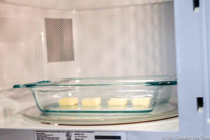 butter in a glass bowl in the microwave
