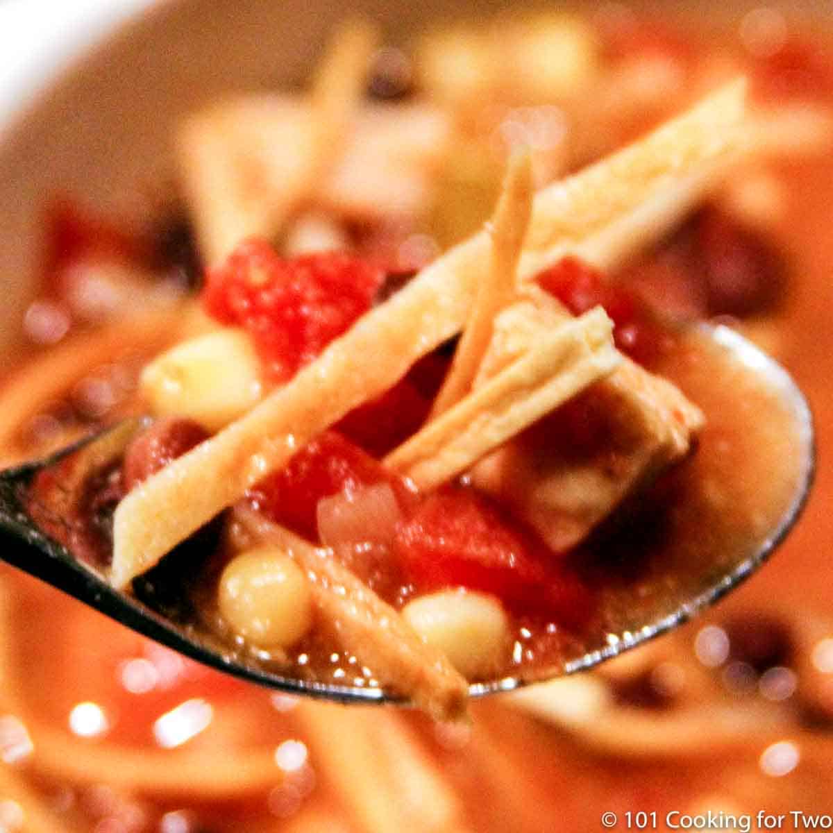 chicken tortilla soup on a spoon