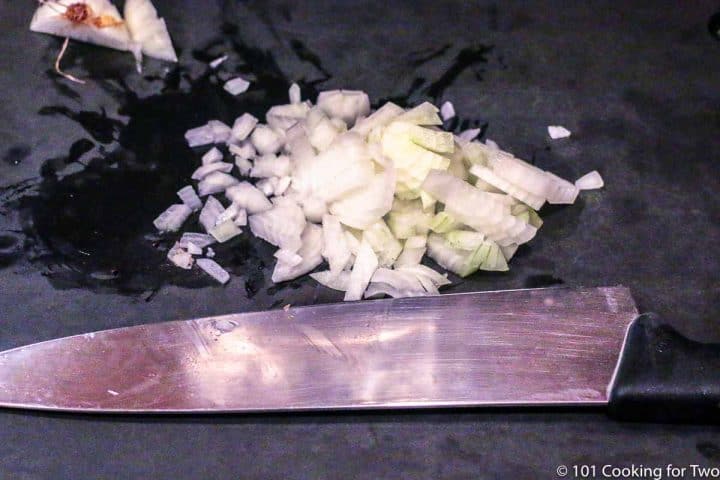 chopped onion on a black board