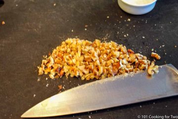 chopped walnuts on a black board