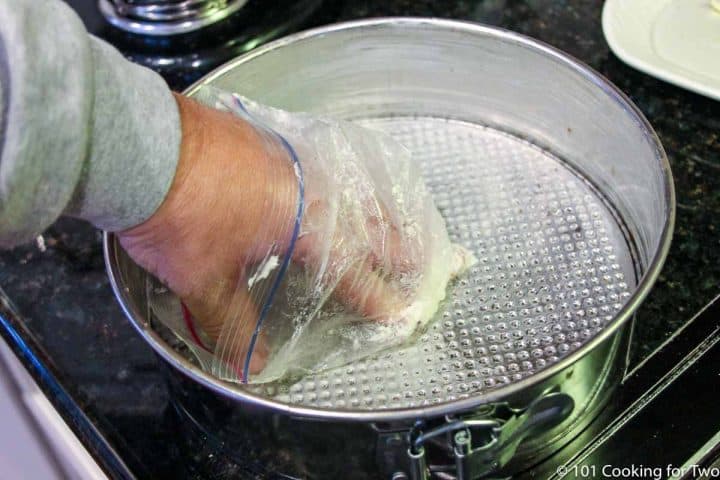 coating a springform pan with butter using a baggie