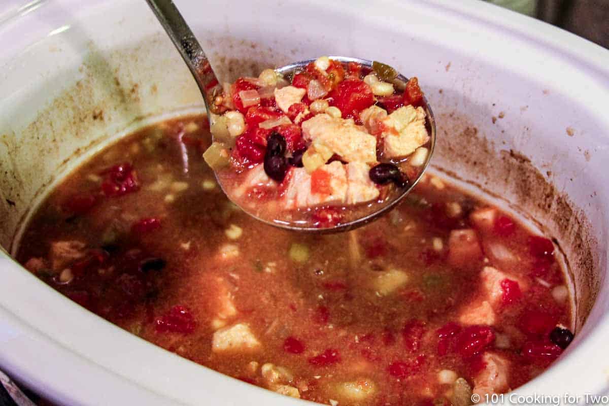 cooked soup in a ladle.