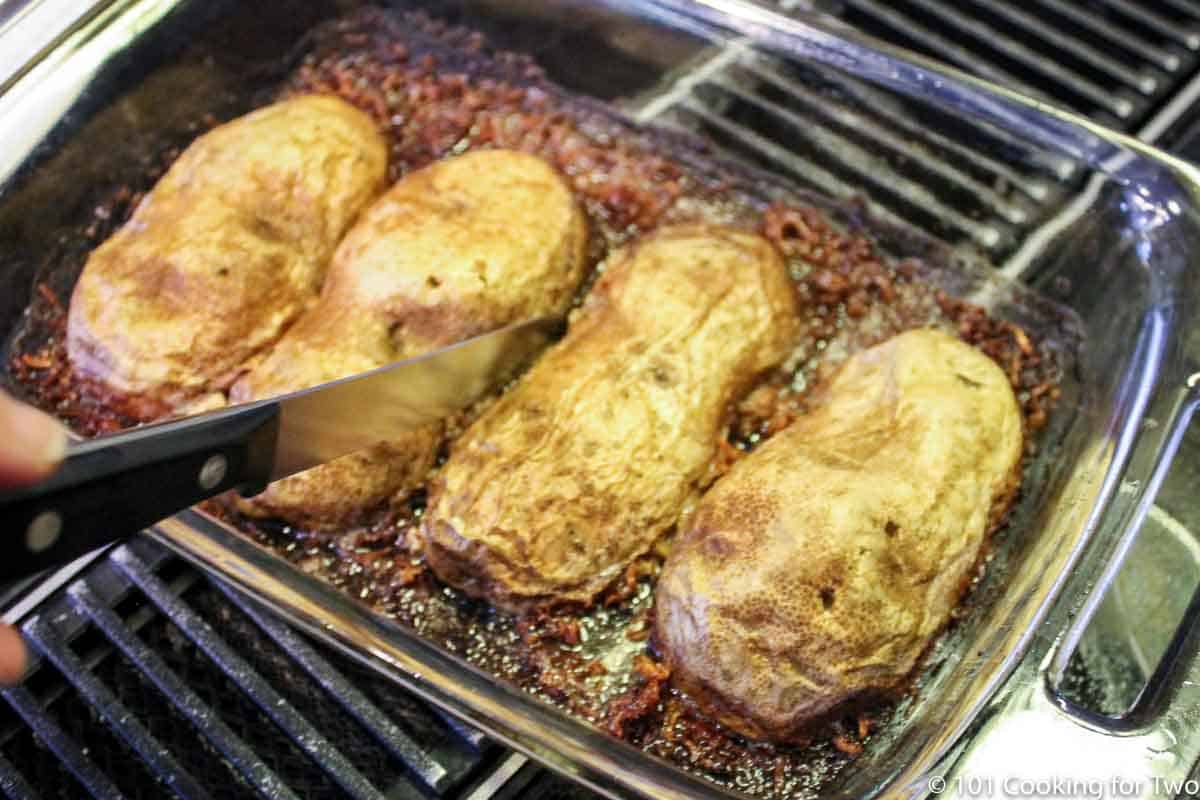 cutting between the potatoes to release them from the pan.