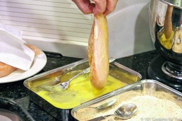 dipping chicken breast in the egg coating