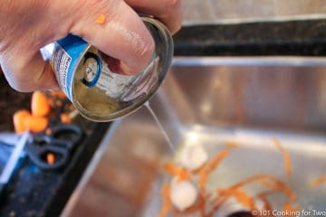 draining pineapple over a sink