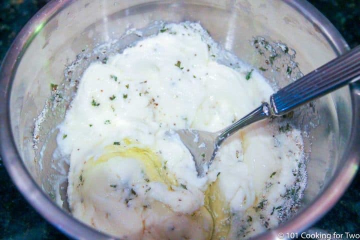 mixing ricotta cheese with an egg.