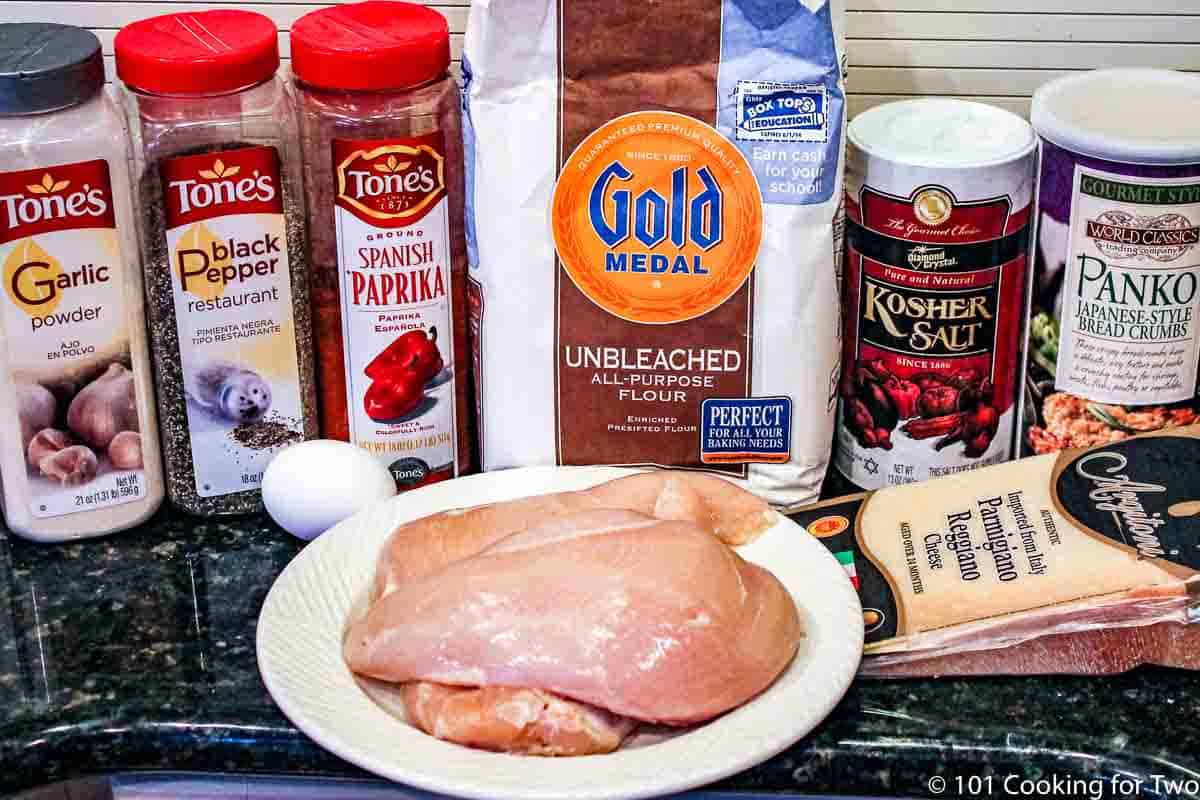 raw chicken with Parmesan and spices.