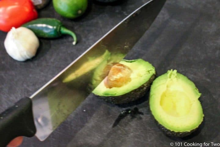 removing the pit of the avacado with a knife