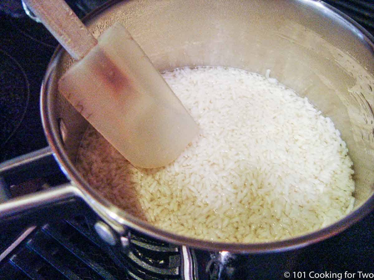 uncooked rice in a large frying pan.