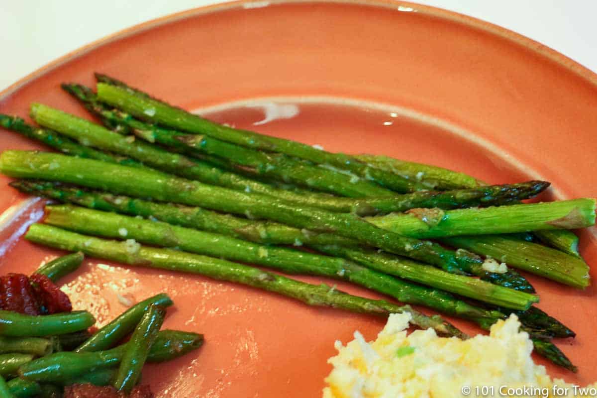 Parmesan Asparagus on a orange plate
