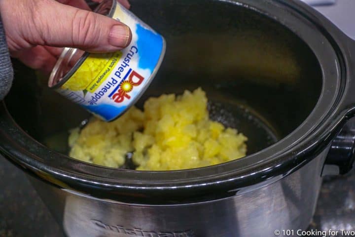 adding crushed pineapple to a small crock pot