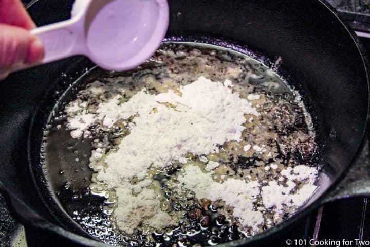 adding flour to pan with oil