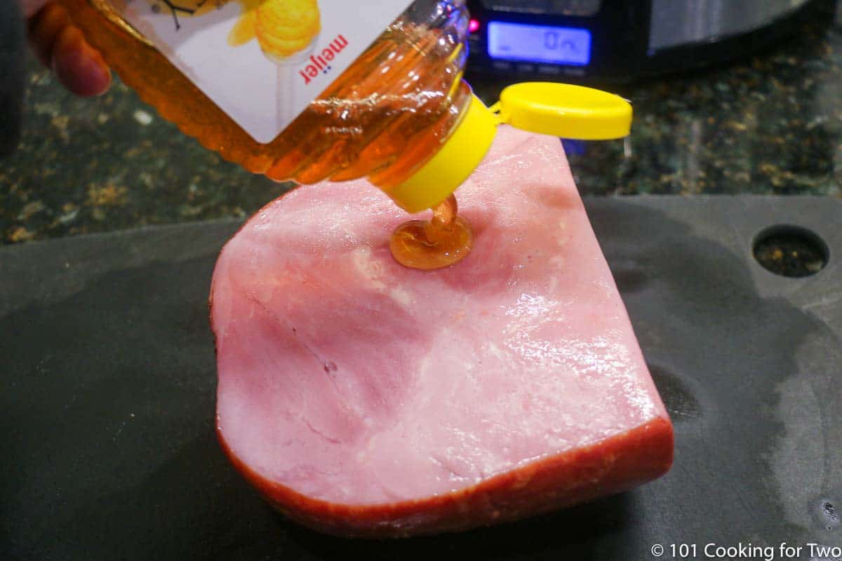 adding honey to coat the ham.