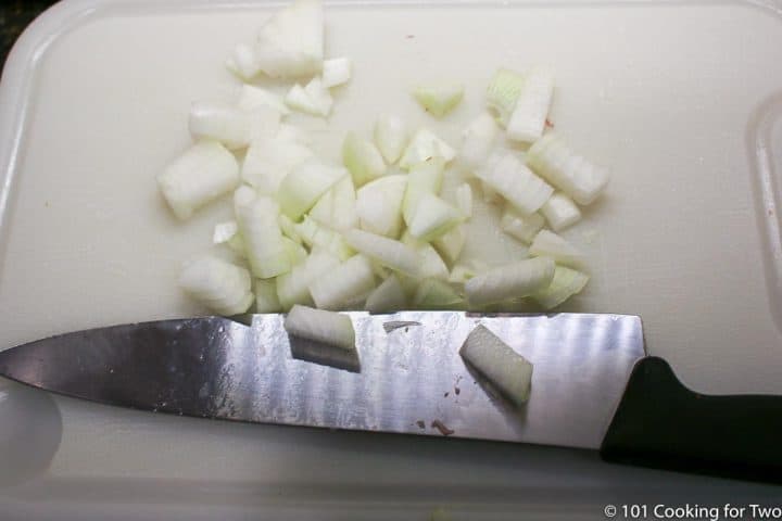 chopped onion on a white board