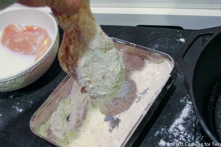 dipping a chicken breast in flour