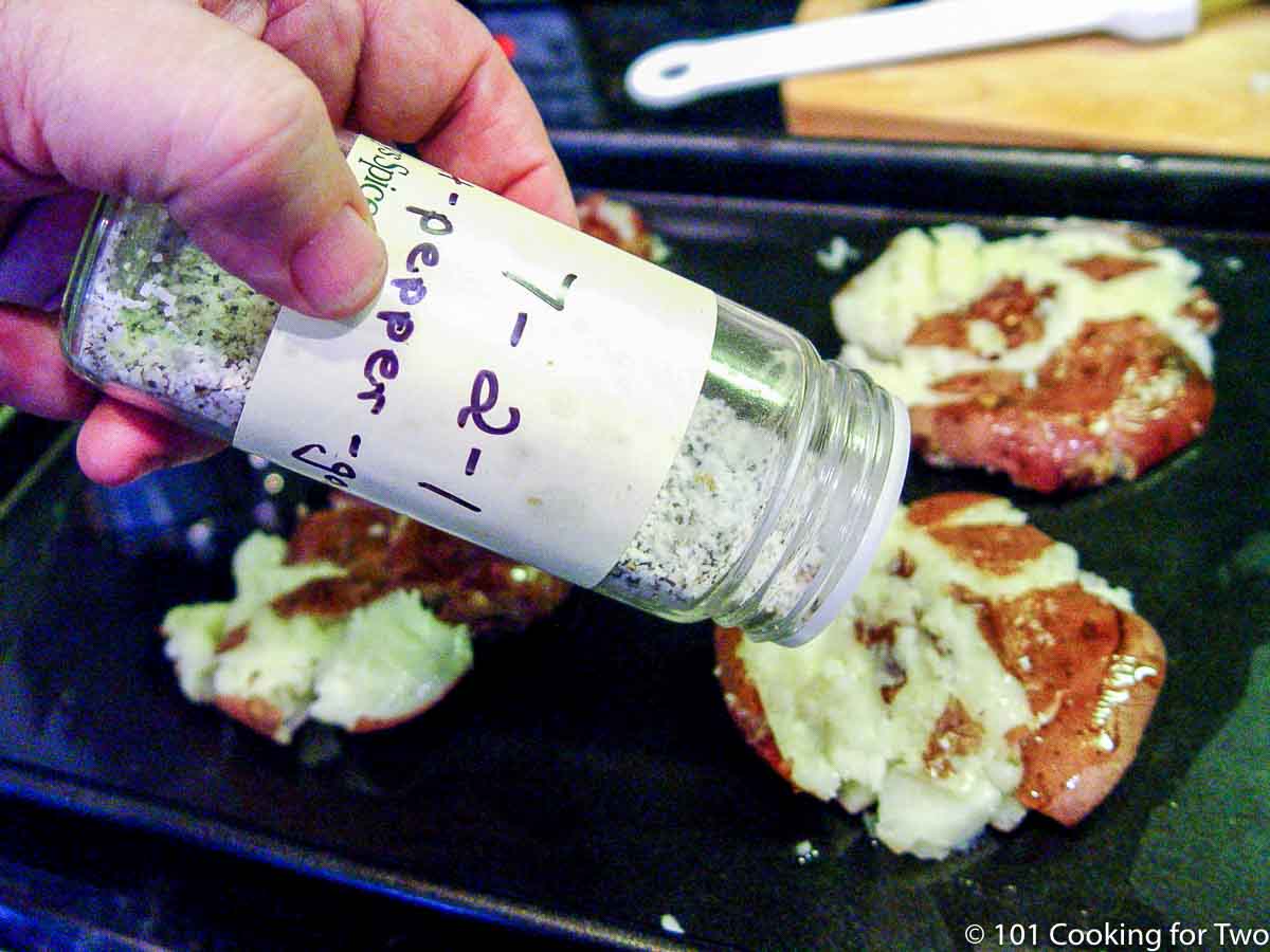 seasoning the potato with salt and pepper.