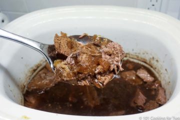shredded beef in a spatula over the crock pot
