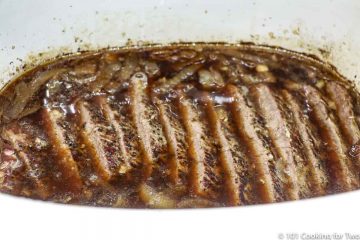 sliced beef roast in the crock pot with liquid