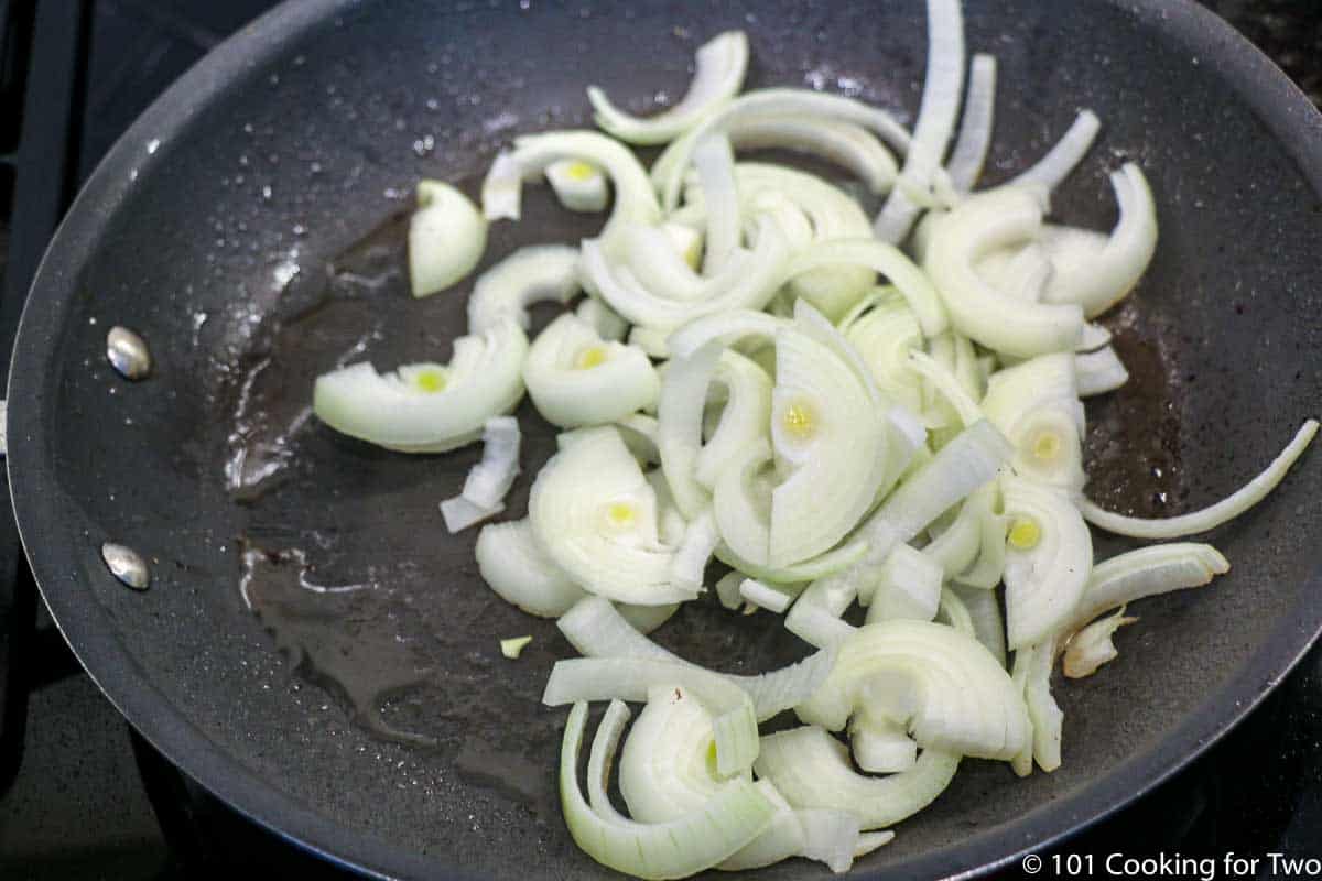 slices of onion in a black pan
