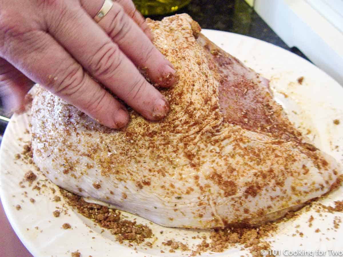 applying rub to turkey breast
