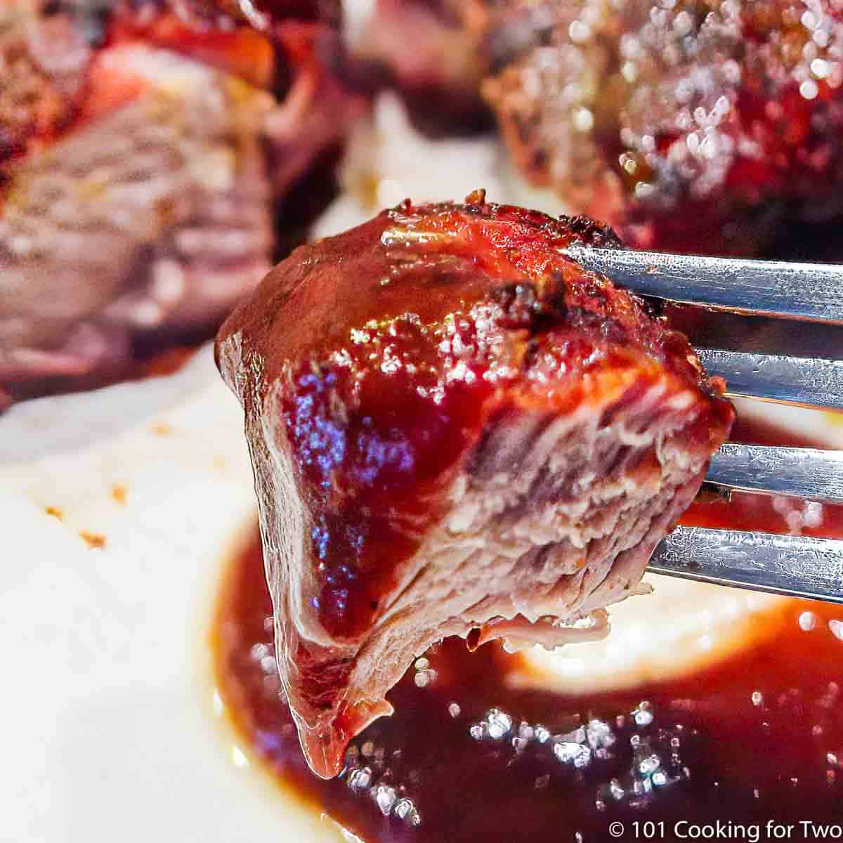 bite of pork rib on a fork
