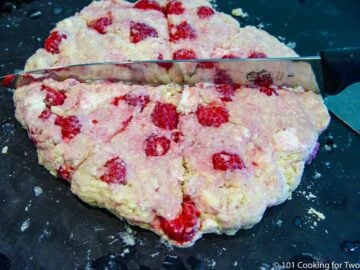 cutting scones from the dough on a bllack board