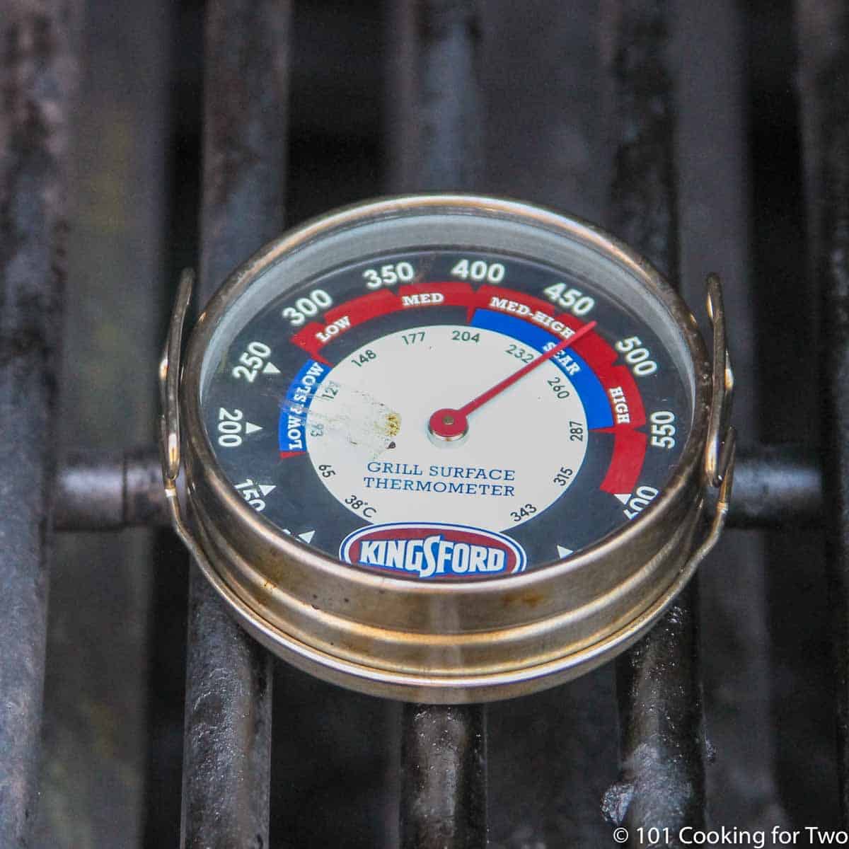 Grill surface thermometer on a grill grate.