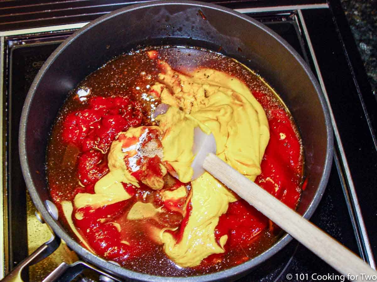 mixing ingredients in a black pan.