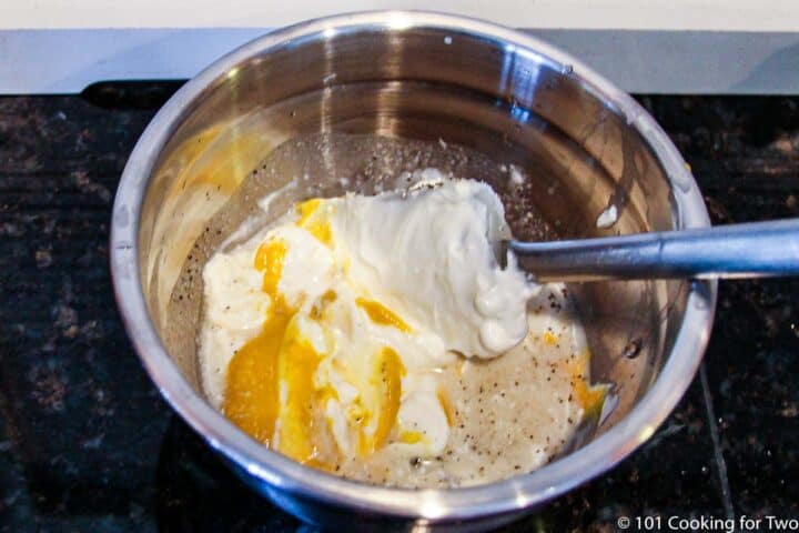 mixing mayo with seasonnings in a metal bowl