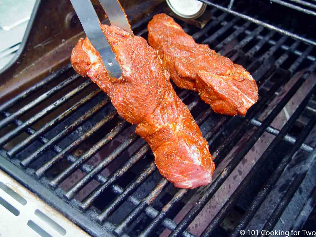 placing country pork ribs on grill