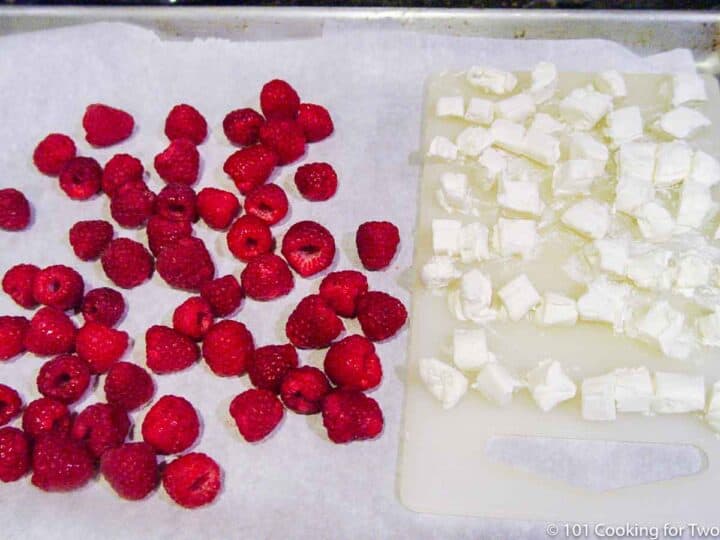 raspberries and cream cheese on a tray