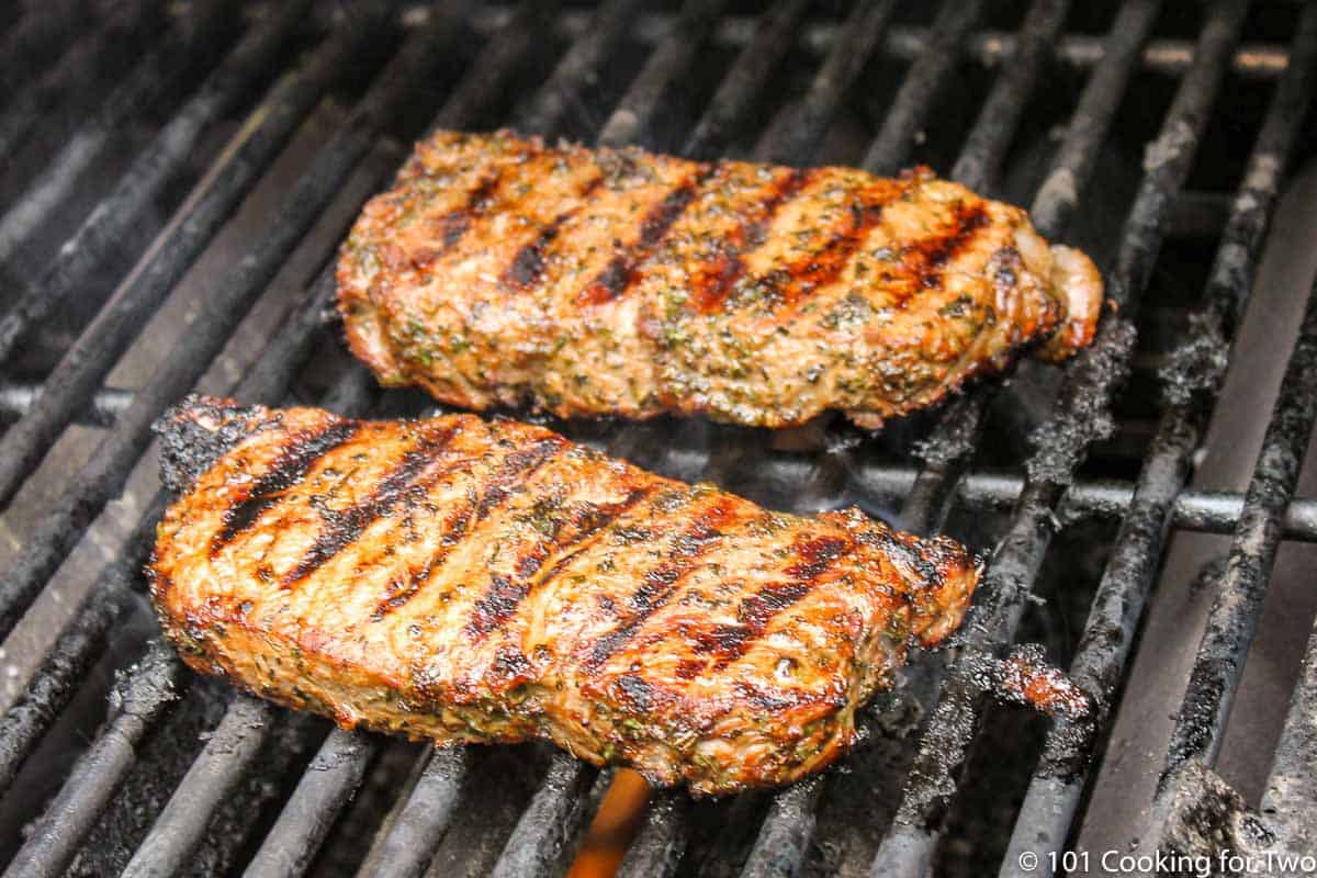 marinade steak cooking on the grill.