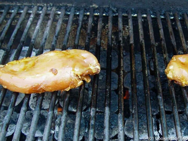 marinaded chicken on a gas grill.