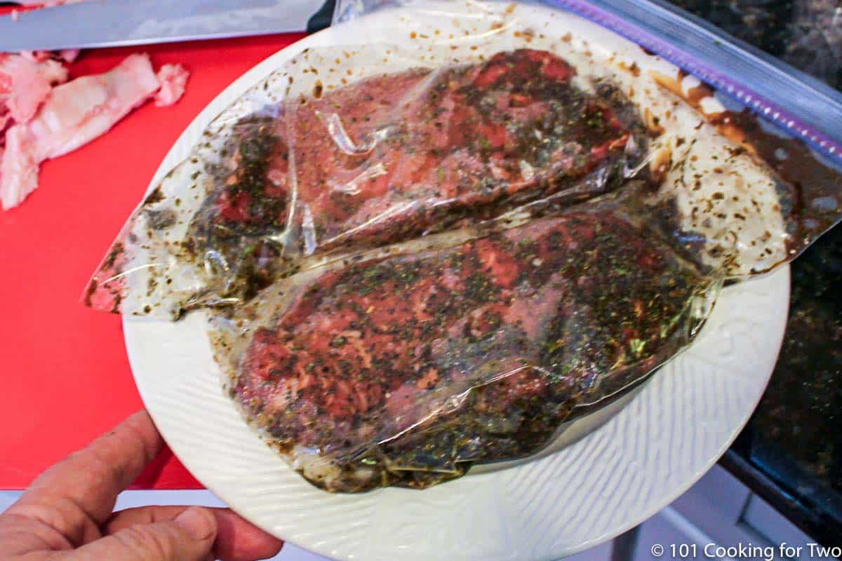 steaks marinating in a bag.